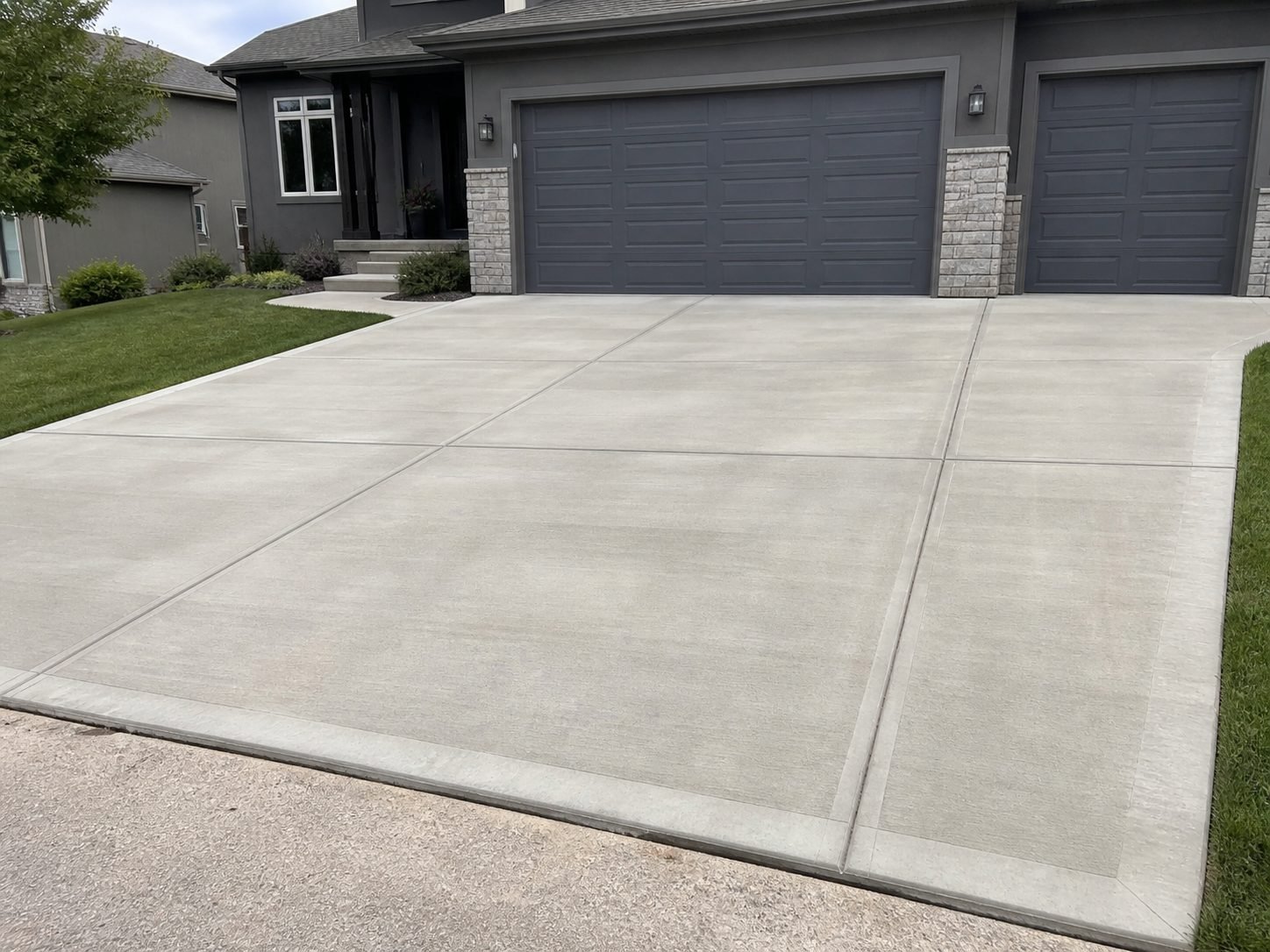 Concrete outdoor area with hardscape and grade change work in a Kansas City area backyard